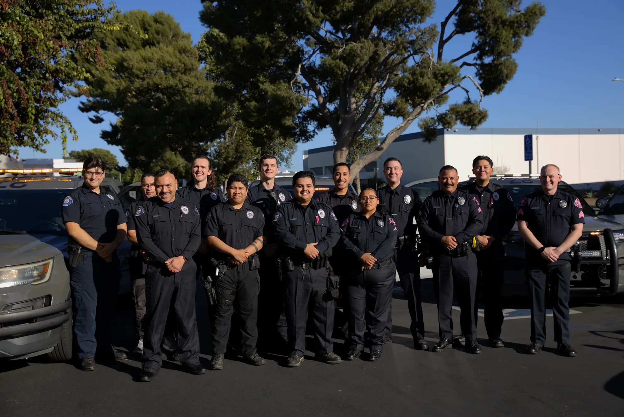 Smiling Sunset Safety Agency team in front of the patrol fleet